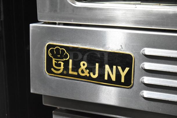 L&J NY stainless steel convection oven with view-through doors, metal racks, thermostatic controls, on commercial casters.