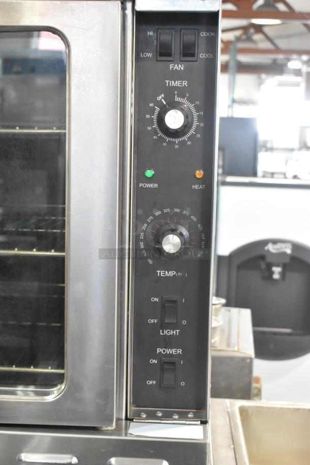 L&J NY stainless steel commercial convection oven with view-through doors, thermostatic controls, and metal racks on casters.