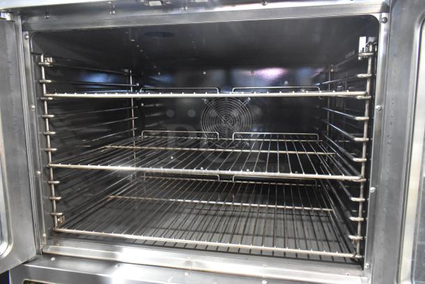 L&J NY stainless steel full-size convection oven with view-through doors, metal racks, thermostatic controls, and commercial casters.