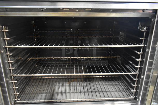 L&J NY stainless steel commercial convection oven with view-through doors, metal racks, thermostatic controls, on casters.