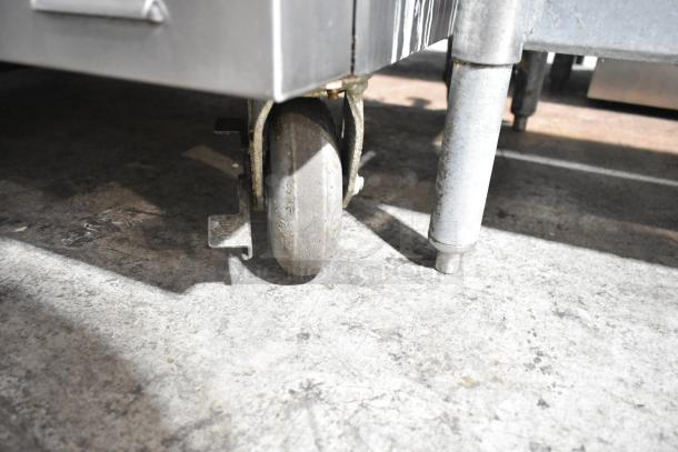 L&J NY stainless steel convection oven on a commercial caster, showing wear on the wheel.