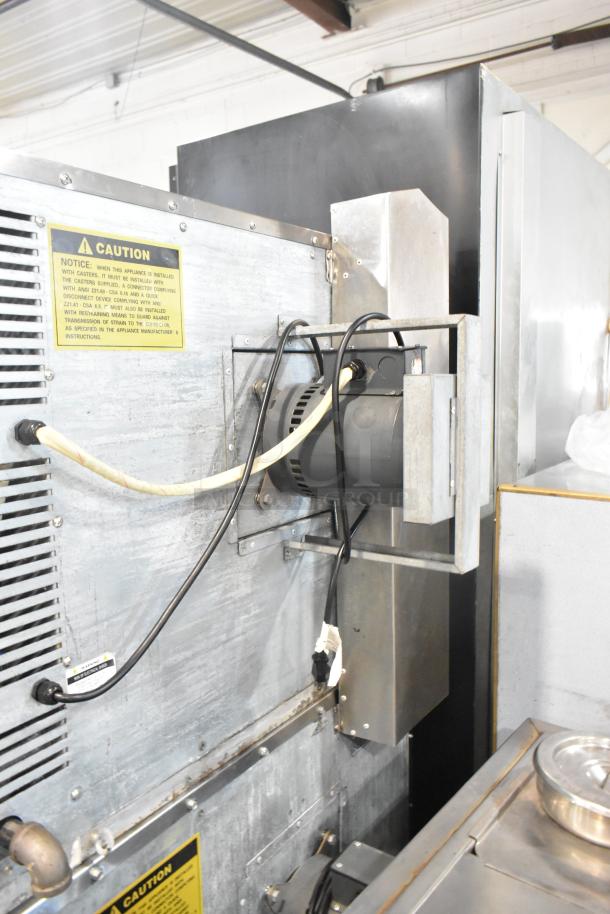 L&J NY stainless steel commercial convection oven with view-through doors, metal racks, thermostatic controls, and caution label.
