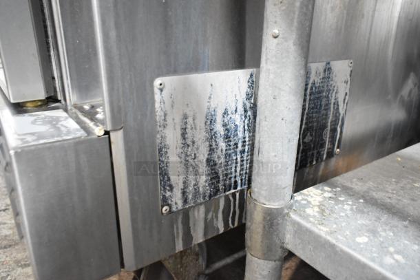 Stainless steel L&J NY commercial convection oven side panel and casters with visible wear.