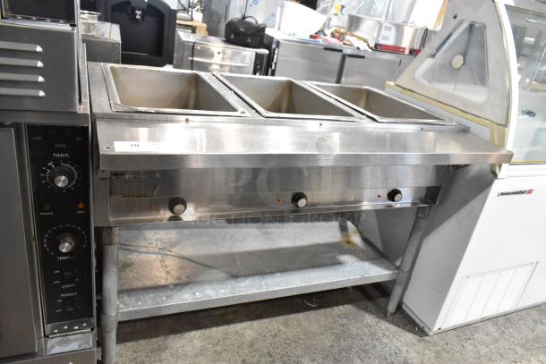 Eagle stainless steel 3-bay steam table with metal under shelf; features temperature control knobs; used condition.