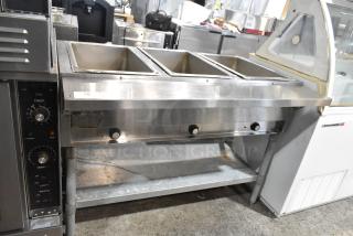 Eagle stainless steel 3-bay steam table with metal under shelf; features temperature control knobs; used condition.