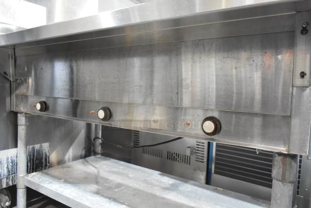 Eagle stainless steel commercial 3-bay steam table with metal under shelf, featuring adjustable knobs, in used condition.
