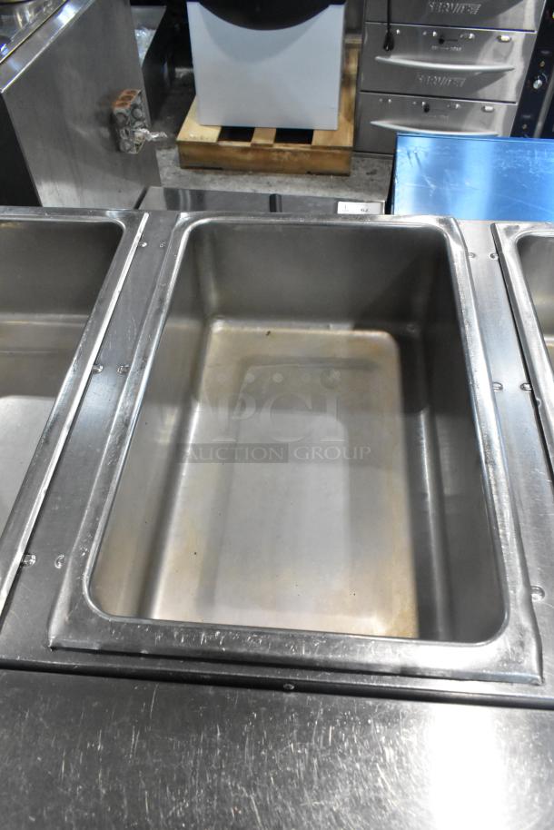 Eagle stainless steel 3 bay steam table with metal under shelf, used condition, features deep rectangular compartments.