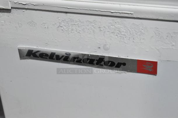 Kelvinator metal commercial ice cream dipping cabinet, visible brand logo, 115 volts, 1 phase, signs of wear.