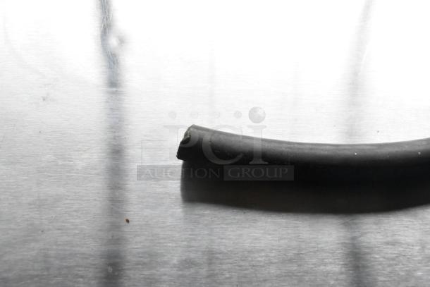 Close-up of a black rubber hose on a stainless steel surface. Image does not match the item's description of a commercial convection oven.
