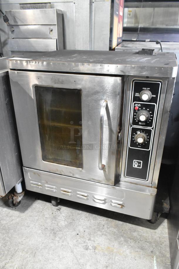 Stainless steel half-size convection oven with view-through door, metal racks, and thermostatic controls, used condition.