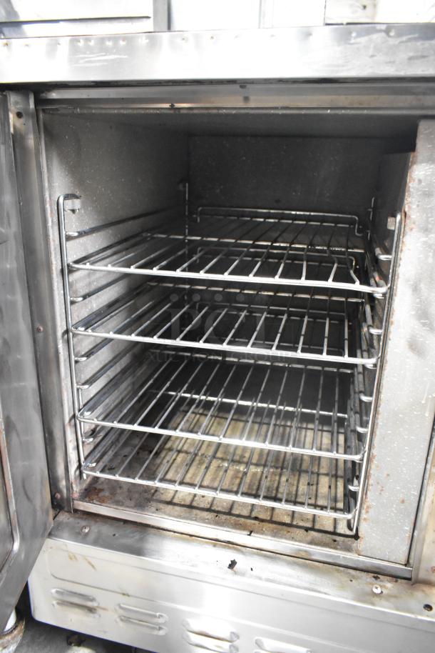 Stainless steel commercial half-size convection oven, view-through door, metal racks, thermostatic controls, used condition.