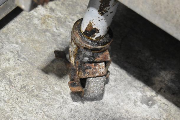 Rusted caster of Pitco Frialator SSPG14 pasta cooker. Visible wear, indicative of heavy commercial use.