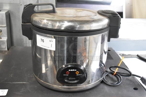 Amko AK-60ERC metal countertop rice cooker, 115 volts, 1 phase. Features cooking and keep-warm settings, visible minor wear.