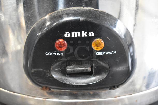 Amko AK-60ERC Rice Cooker, metal finish, 115V, 1 phase. Features cooking and keep warm indicators. Used condition.