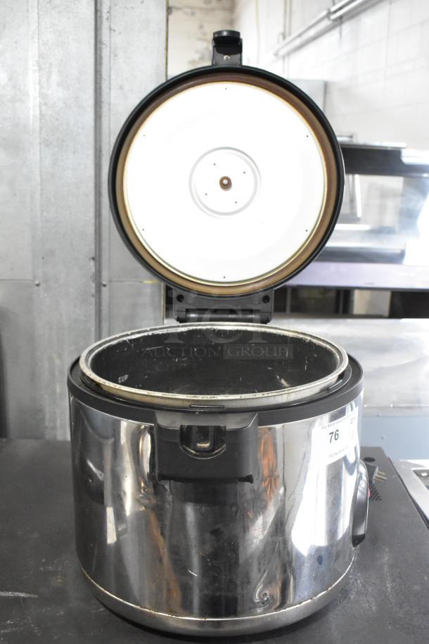 Amko AK-60ERC metal countertop rice cooker. Visible wear. 115 volts, 1 phase. Lid open, inner pot shown.
