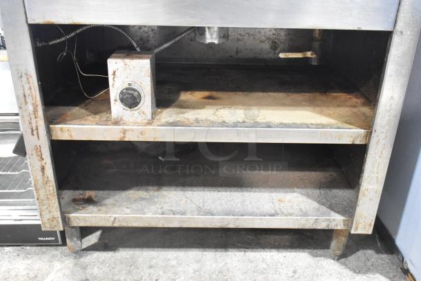 Stainless steel commercial 2 well steam table with cylindrical drop-in bins, showing signs of rust and wear.