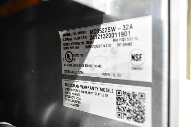 Close-up of label on Scotsman MC0522SW-32A ice machine showing model, serial number, UL and NSF certifications.