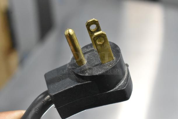 Close-up of the plug for a Beverage Air UCR67A commercial cooler, showing a three-prong design.