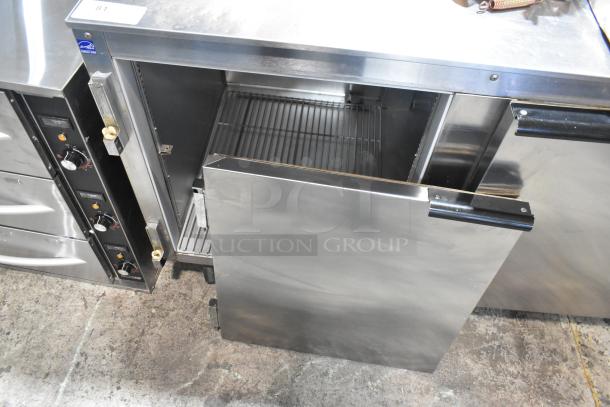 Beverage Air UCR67A stainless steel 2-door undercounter cooler on casters; 115V, 1 phase; open view, commercial kitchen setting.