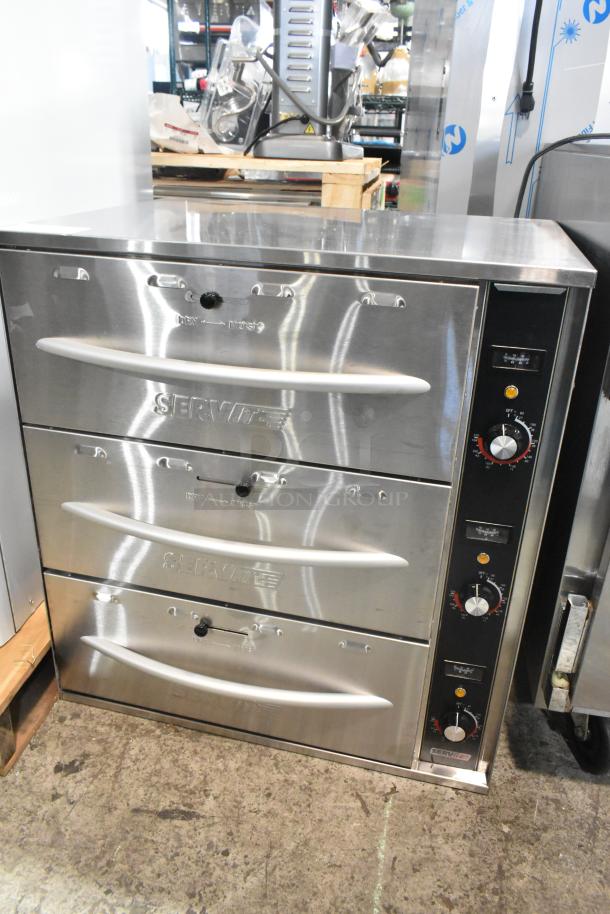 BRAND NEW SCRATCH AND DENT! 2024 ServIt 423WDSFS3 stainless steel triple drawer warmer, 120V, 1 phase, with control knobs.