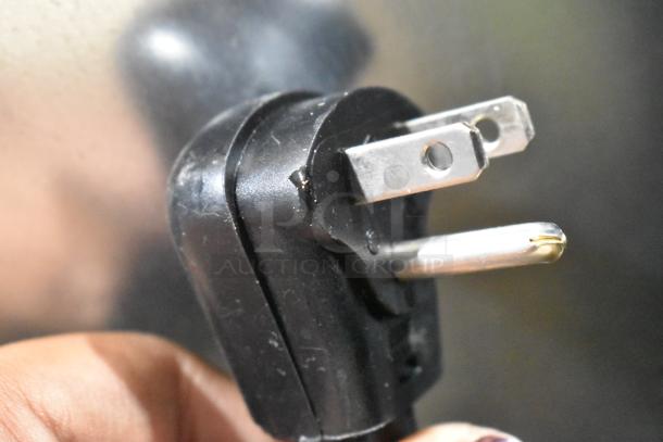 Close-up of a power plug for the 2025 Avantco 194HBN12022 ice dispenser, showing a standard three-prong design.