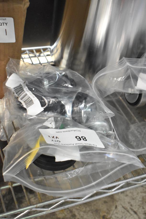 Two brand new Regency 5" poly casters in sealed bags on a shelf, item codes 460SHPCRTPRLG and 460SHPCRTPFLG.