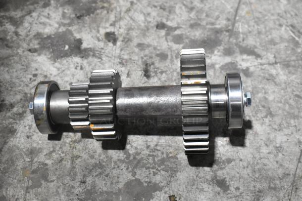 New metal gear assembly with visible scratches and dents; industrial-grade, sturdy construction, and precise craftsmanship.