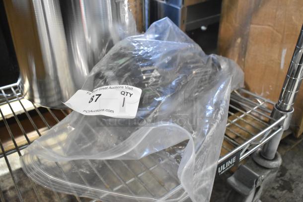 Brand new metal piece in plastic packaging with "Scratch and Dent" tag, labeled "87, QTY 1" for auction.