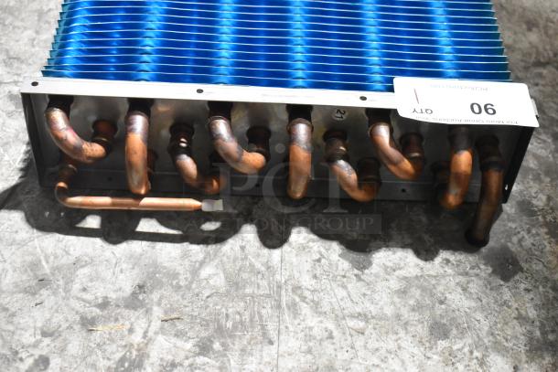 Brand new Avantco 19386562 evaporator coil for VAC-36W/B. Scratch and dent condition. Copper tubing, blue fins, auction tag 90 visible.