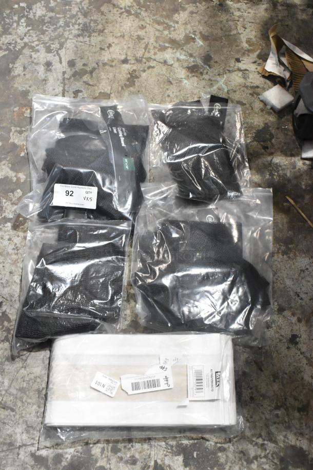 5 brand new items, including Lavex vacuum bags and Choice cutting board liners, in sealed packaging on concrete floor.