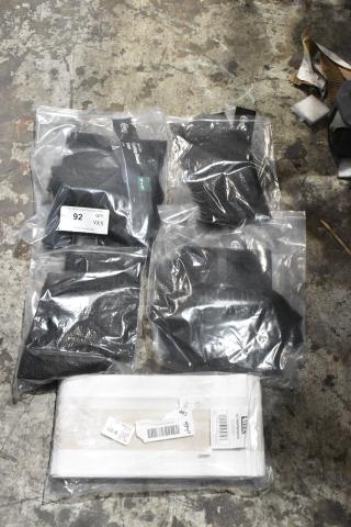 5 brand new items, including Lavex vacuum bags and Choice cutting board liners, in sealed packaging on concrete floor.