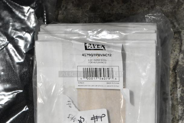 5 new scratch and dent items: Lavex 9 Qt. Paper Bag pack, 4579QTPBVAC12 label visible, 10 per case.