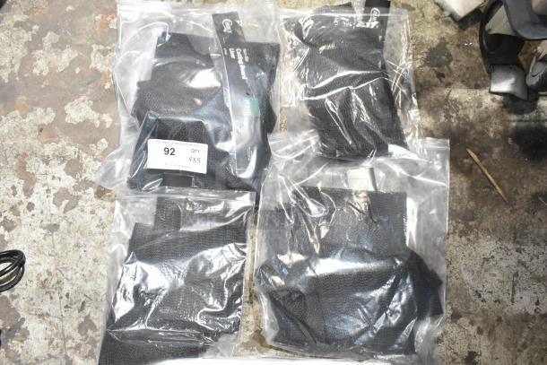 5 sealed black non-slip cutting board liners, each in clear packaging marked "92 QTY VX5" for auction. Brand new condition.