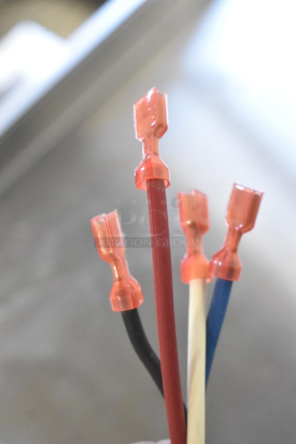 Red and black wire connectors from Fasco 71218459 Motor, illustrating wiring components.