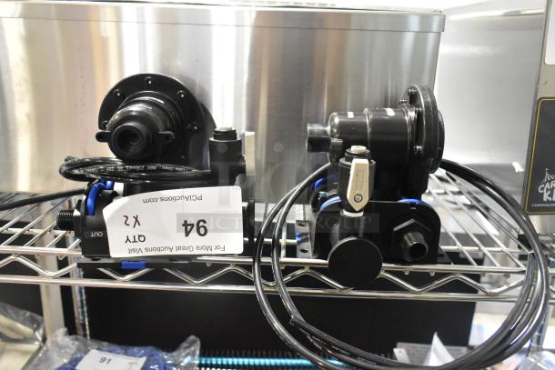 Brand new Bunn filter head with minor scratches and dents, includes tags indicating quantity (x2), on metal shelf.