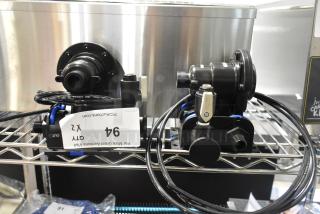 Brand new Bunn filter head with minor scratches and dents, includes tags indicating quantity (x2), on metal shelf.