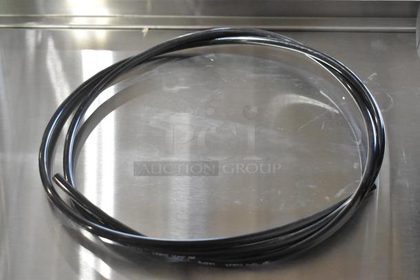 Black cable coil on metal surface for Bunn Filter Head, new scratch and dent condition, enhances bid value.