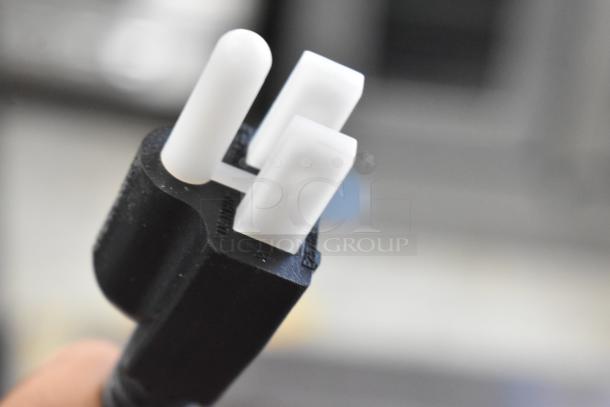 Close-up of black and white power plug for 2024 Carnival King 382CDPW3 3 Qt. Triple Cone Dip Warmer, 120V, 1 Phase.