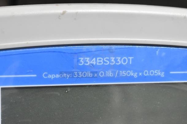 AvaTek 334BS330T digital bench scale, 330 lb. capacity, with tower display, scratch and dent condition, label shows model details.