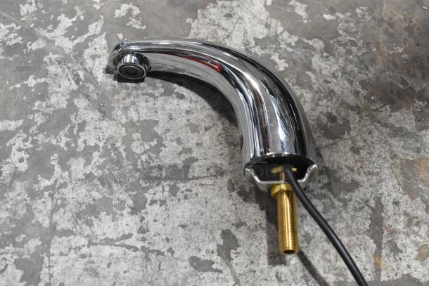 Brand new chrome faucet with minor scratches and dents. Features a curved spout, brass connection, ready for installation.