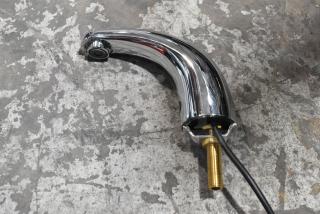 Brand new chrome faucet with minor scratches and dents. Features a curved spout, brass connection, ready for installation.