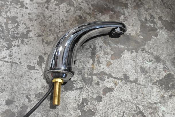 Brand new chrome faucet with slight scratches and dents; features brass connector and attached cable.