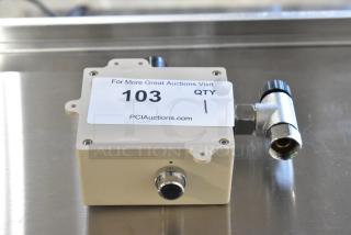 "New scratch and dent box with connector, item 103, labeled by PCI Auctions. Visible minor wear on casing."