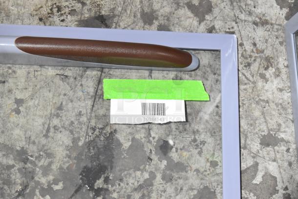 Avantco 36084343 sliding glass bottom lid, new condition, with label showing barcode and model number on a work surface.
