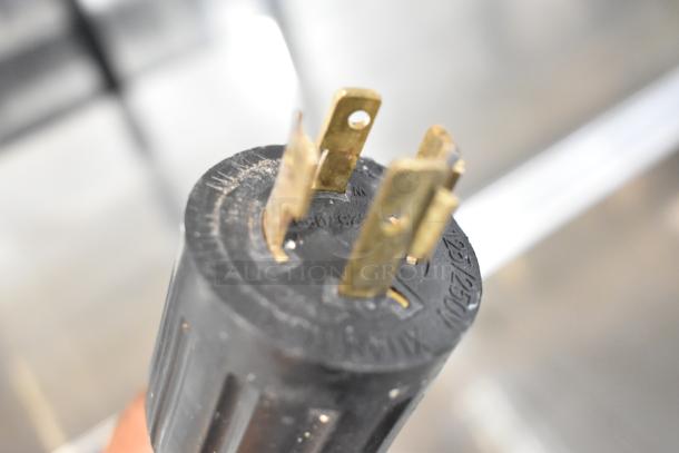 Close-up of Federal Industries RSSM560SC-5 merchandiser plug, showing metal prongs for 120/208-240V, 1-phase power.