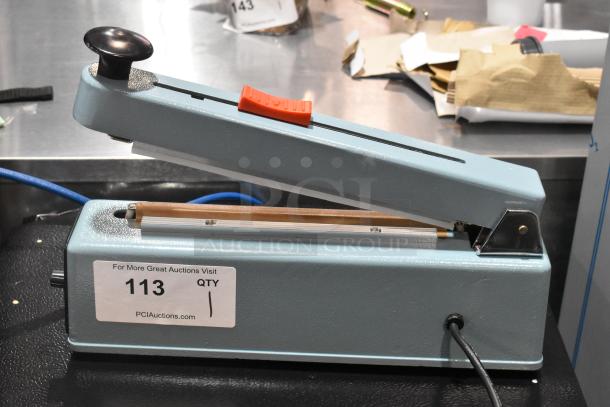 BRAND NEW Hualian FS-200M Metal Hand Impulse Sealer with Middle Cutter, 110V, 1 Phase, shown unboxed.