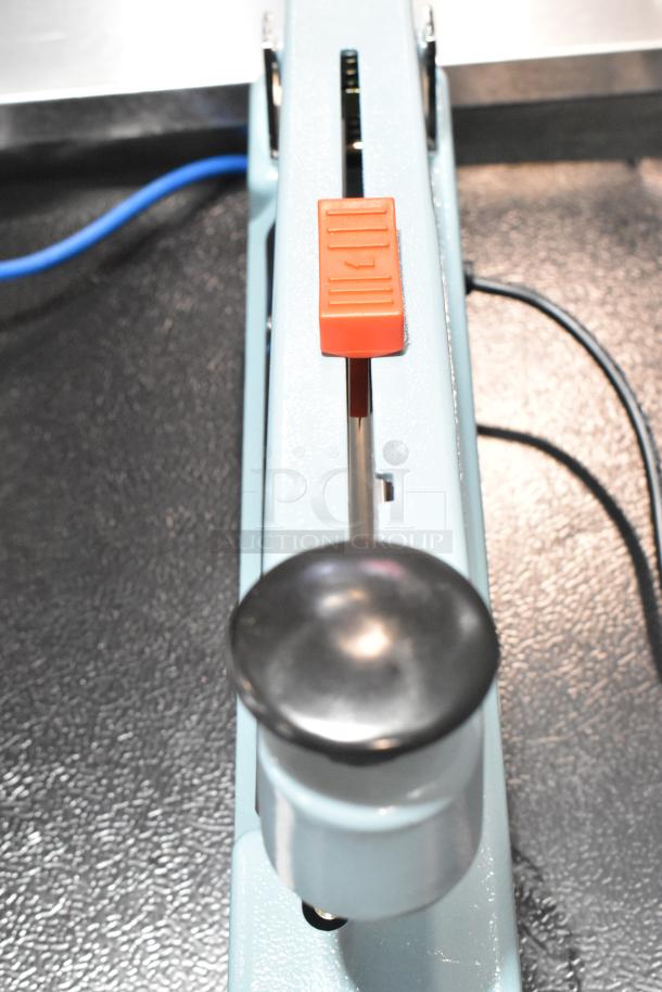BRAND NEW Hualian FS-200M metal countertop hand impulse sealer, middle cutter, 110V, 1 phase.