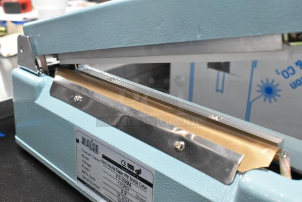 BRAND NEW Hualian FS-200M metal countertop hand impulse sealer with middle cutter, 110V, 1 phase, shown in open position.