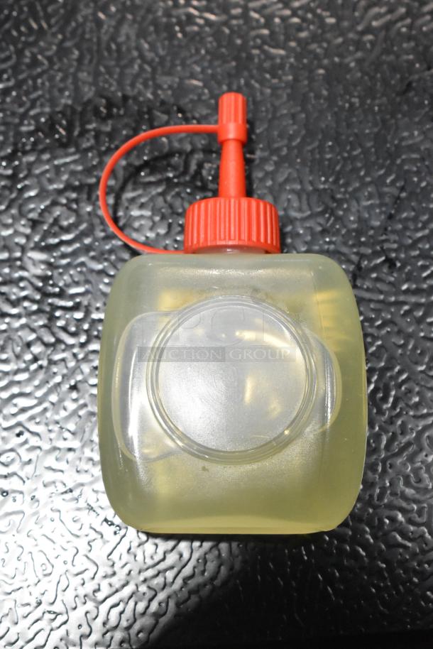 Estella lubricating oil in a clear bottle with a red cap, new condition, for SLM13, SLM12, SLAS13, SLA13 models.