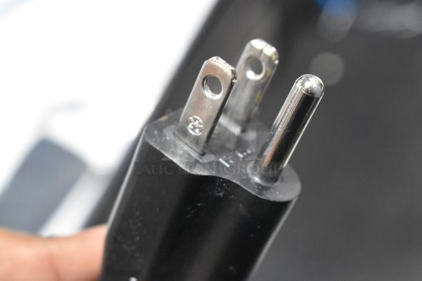 Close-up of a black three-prong plug attached to the AvaMix 928RDM1CRM Retro Cream Drink Mixer, 120V, 1 Phase.